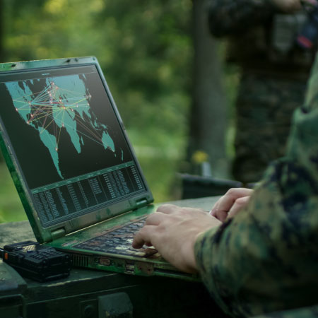 A warfighter working on mobile laptop.